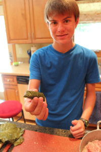 Aaron with a Grape Leave rolled